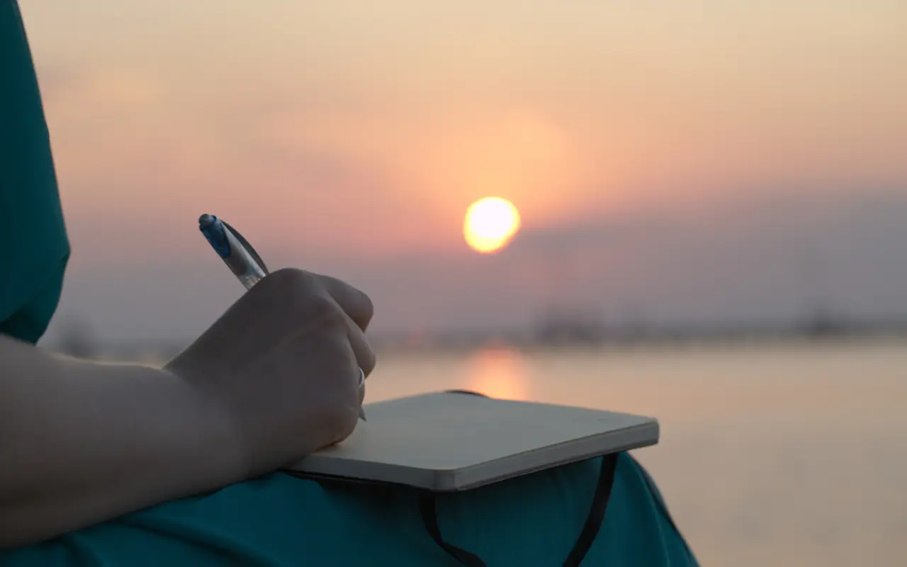 Notebook writing in a sunset