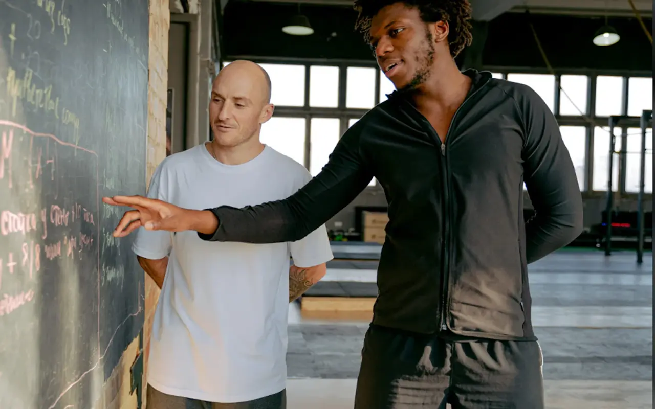 Discussing training with a coach in the gym
