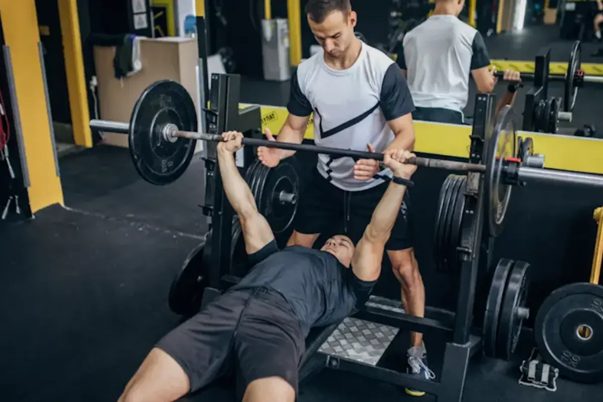 Men training bench press in the gym