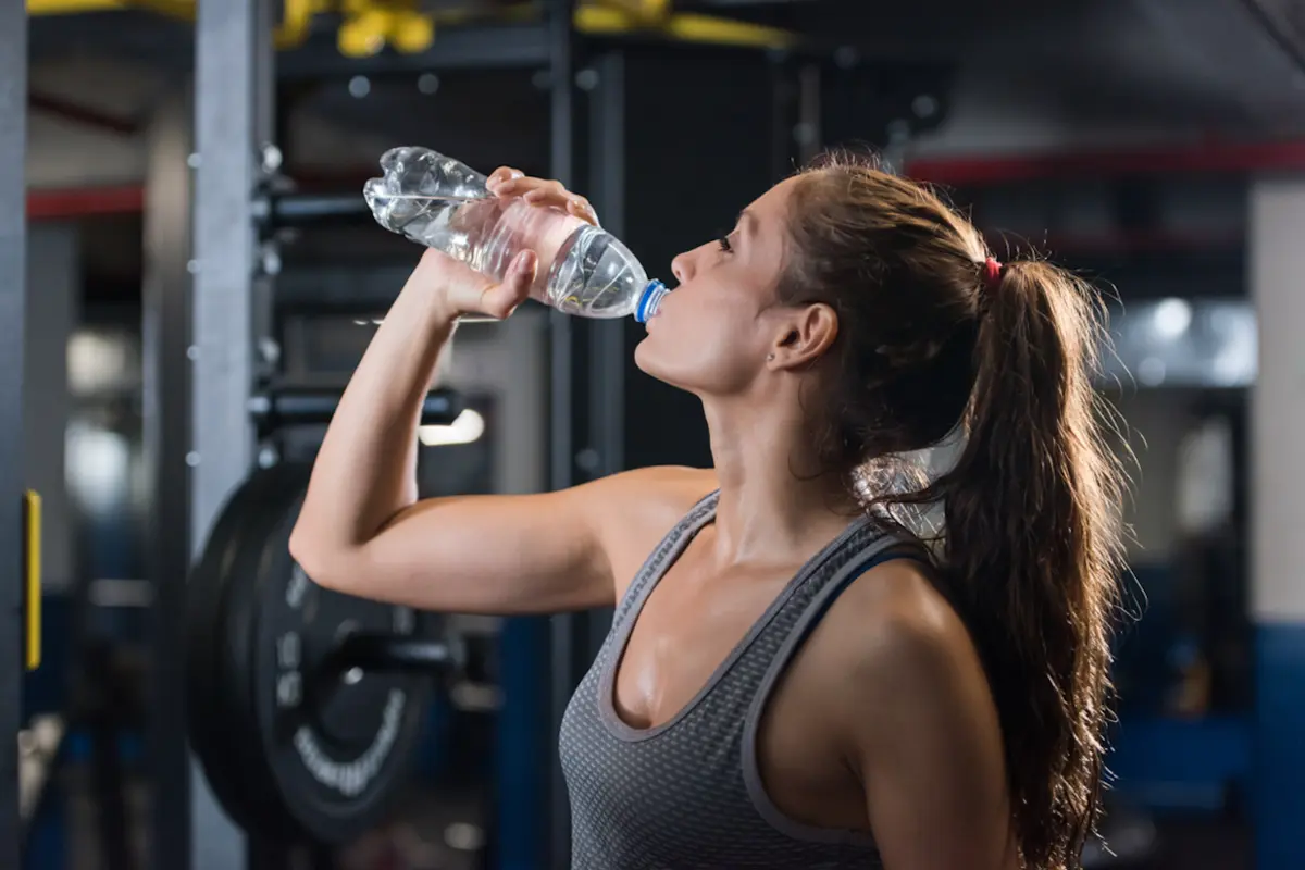 Woman drinking in the gym