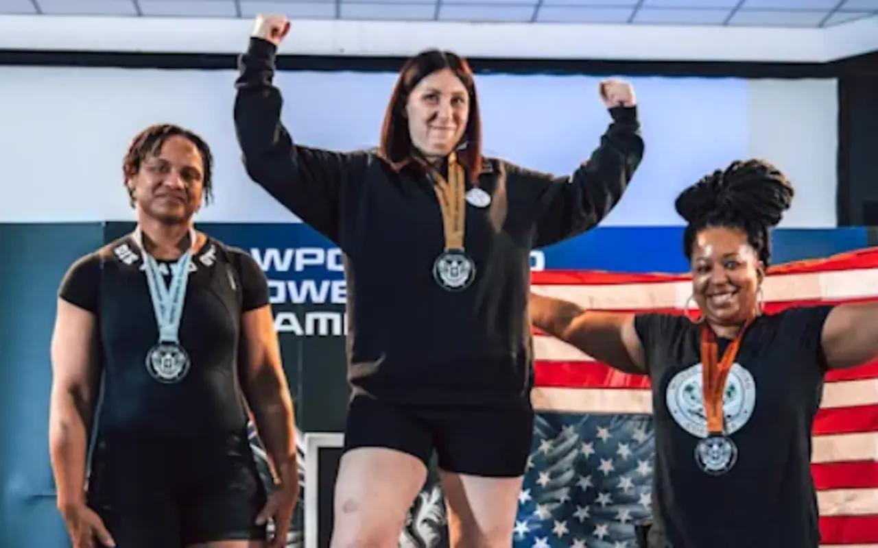 Women powerlifters on the competition podium together