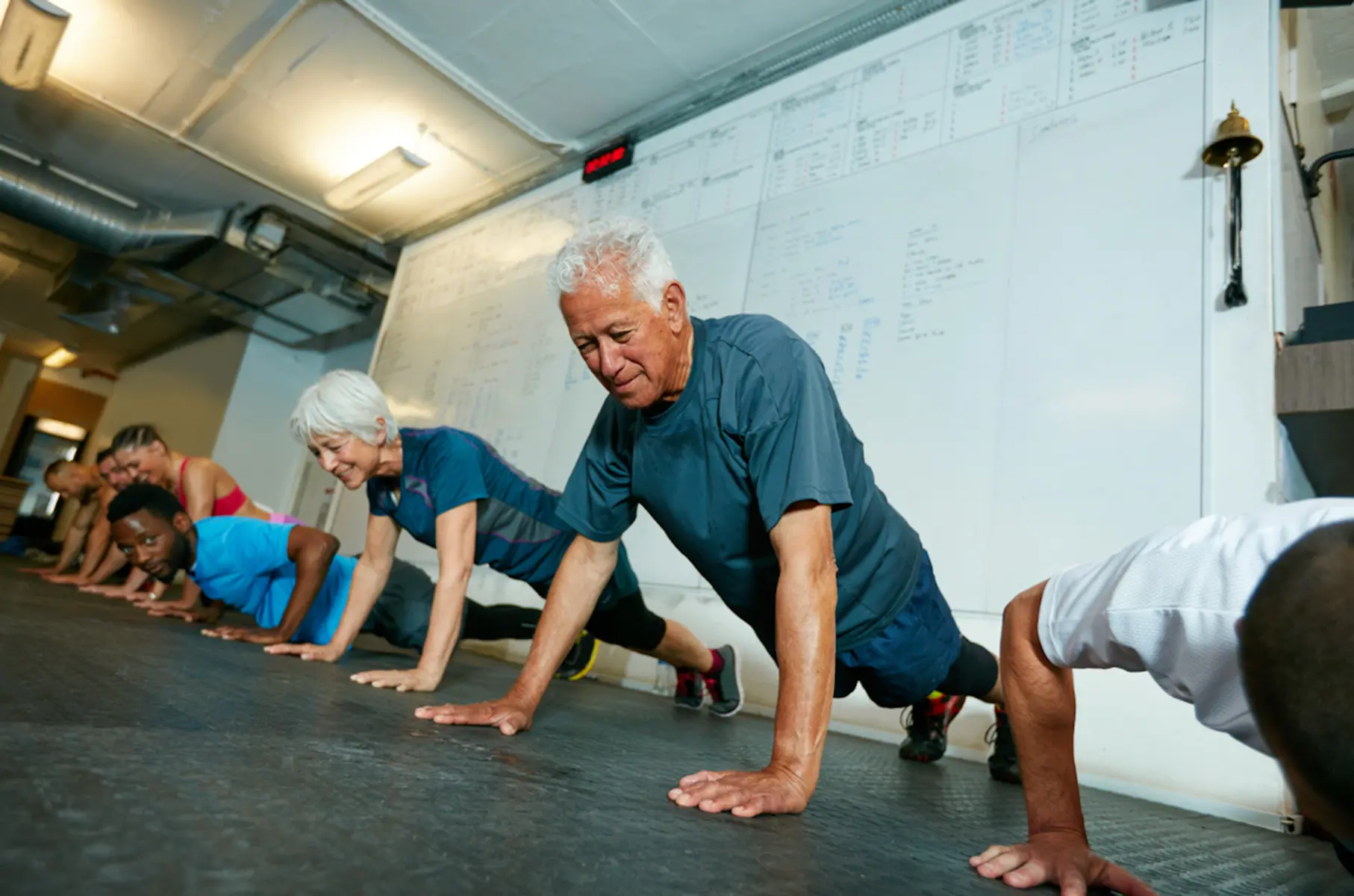 Older adults doing push ups in a class