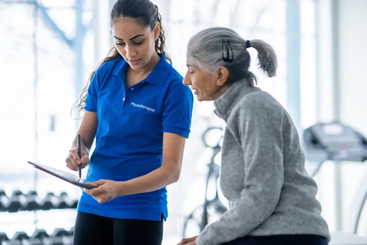 Older woman with a sports physiotherapist