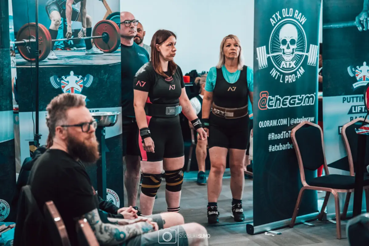 Older women lifters at competition at the side of the platform