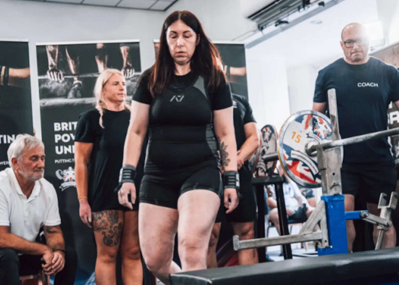 Woman walking out to do a competition bench press
