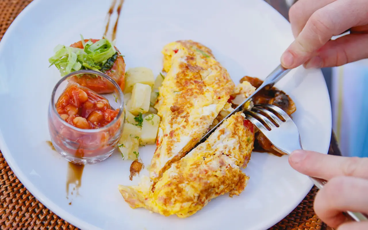 Omelette</p>
<h2><strong>Practical Tips for Incorporating Adequate Protein into Your Diet</strong></h2>
<hr />
<h3><strong>Strategies for Meal Planning and Preparation</strong></h3>
<p>Effective meal planning and preparation strategies are essential for powerlifters aiming to optimise their food intake and protein intake, and nutrient timing plays a crucial role in these approaches. These strategies ensure a consistent and adequate supply to meet the demands of intensive training and recovery while accommodating busy schedules.</p>
<ul>
<li><strong>Plan Ahead</strong>: Begin by mapping out your weekly meals, focusing on incorporating various high-quality sources across all meals. This planning phase is crucial for achieving a balanced intake of nutrients and avoiding dietary monotony.</li>
<li><strong>Batch Cooking</strong>: Prepare and cook protein-rich foods in bulk, such as grilling chicken breasts, roasting lean cuts of meat, or cooking a large pot of beans or lentils. This saves time and guarantees you have ready-to-eat options throughout the week.</li>
<li><strong>Protein-Rich Snacks</strong>: Stock up on easy, portable snacks such as Greek yoghurt, cottage cheese, hard-boiled eggs, or a handful of almonds. These can help you reach your protein goals between meals or when on the go.</li>
<li><strong>Leverage Leftovers</strong>: Creatively repurpose leftovers into new meals. For example, leftover grilled chicken can be added to salads, soups, or wraps to boost macro content.</li>
<li><strong>Use Technology</strong>: Numerous apps and online tools are available to help track your daily intake, offering insights into your nutritional status and helping you stay on target with your goals.</li>
</ul>
<h3><strong>Suggestions for Protein Supplements if Needed</strong></h3>
<p>While whole foods should always be the cornerstone of your diet, supplements from reputable supplement companies can be a practical addition to ensure you meet your daily requirements, especially on busy days or post-workout.</p>
<ul>
<li><strong>Whey Protein</strong>: A popular choice for post-workout recovery due to its fast absorption rate and high-quality amino acid profile. It can be easily mixed with water or milk for a quick shake.</li>
<li><strong>Casein</strong>: This slow-digesting protein is ideal for consuming before bed, providing a sustained release of amino acids overnight and aiding in muscle repair and growth.</li>
<li><strong>Plant-Based Proteins</strong>: Options like pea, rice, or soy powders are excellent for vegetarians or those with dairy intolerances. They can be used just like whey in shakes or smoothies.</li>
<li><strong>Read Labels Carefully</strong>: Choose products with minimal added sugars and artificial ingredients when selecting a supplement. Look for those that provide a substantial amount of protein per serving (at least 20 grams).</li>
<li><strong>Consult a Professional</strong>: Before incorporating supplements into your diet, consider consulting with a sports nutrition coach or healthcare provider, especially if you have underlying health conditions or specific dietary needs.</li>
</ul>
<h2><strong>Conclusion</strong></h2>
<hr />
<p>Optimizing protein intake is crucial for powerlifters to support strength training, muscle gain, muscle repair, and athletic performance. Recommendations suggest consuming 1.4 to 2.0 grams per kilogram of body weight daily, emphasizing higher needs for athletes in resistance training. This strategy promotes muscle synthesis, which is essential for growth and recovery.</p>
<p>Distributing intake evenly throughout the day is crucial for muscle synthesis and repair. Aim for 20-40 grams per meal to optimize these processes. Include high-quality animal and plant-based sources to provide essential amino acids for muscle growth and strength gains.</p>
<p>Personalisation emerges as a key theme in applying these guidelines, with the acknowledgement that individual needs can vary based on body weight, composition, and specific training goals.</p>
<p>Powerlifters are encouraged to view their intake as a dynamic component of their overall nutrition and training regimen that requires ongoing attention and adjustment.</p>
<h2><strong>Frequently Asked Questions</strong></h2>
<hr />
<p><strong>How much protein should I take immediately within the anabolic window?</strong></p>
<p>20-40g within a few hours is sufficient.</p>
<p><strong>Will I need protein supplements as a powerlifter?</strong></p>
<p>Not necessarily if you can meet requirements through food, but they
