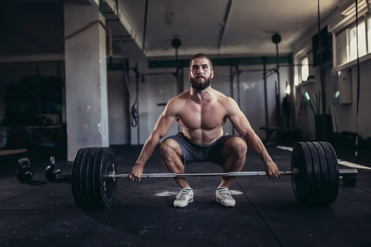 Healthy looking man with a loaded deadlift bar