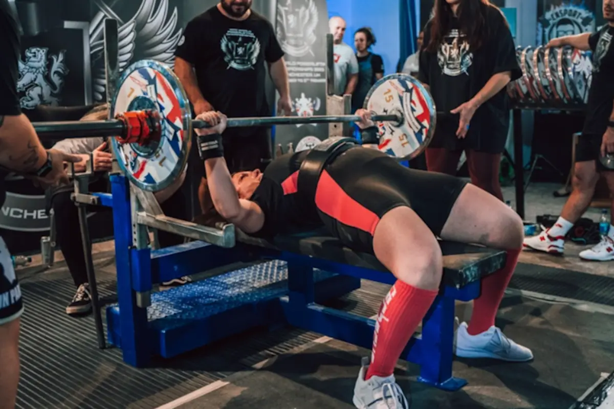 Front view of female competition bench press