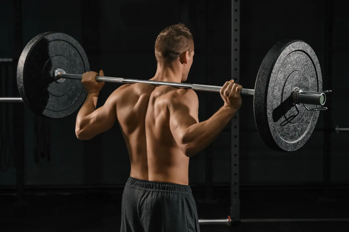 Man with bar in high bar position