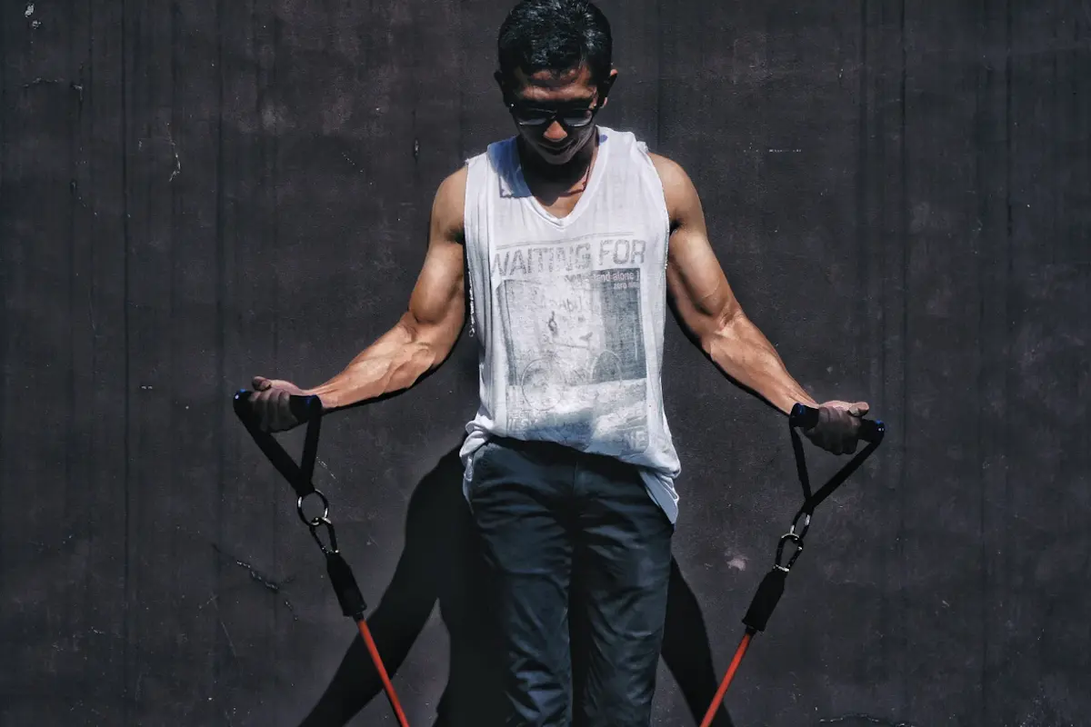 Man using a light resistance band in the gym
