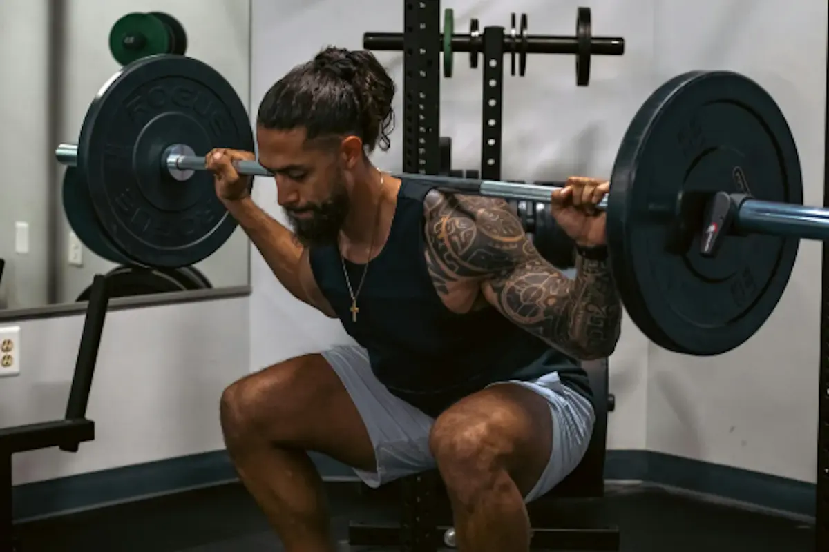 Man performing a barbell back squat