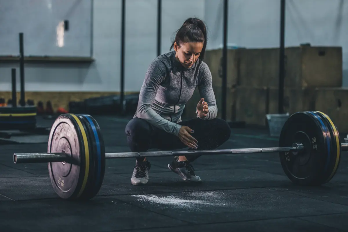 Woman in the gym with a barbell