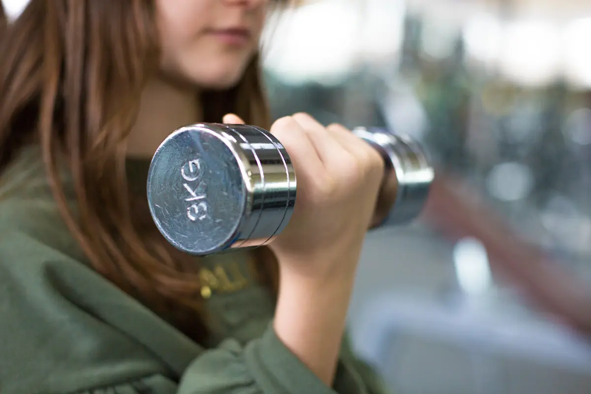 Girl lifting a dumbbell